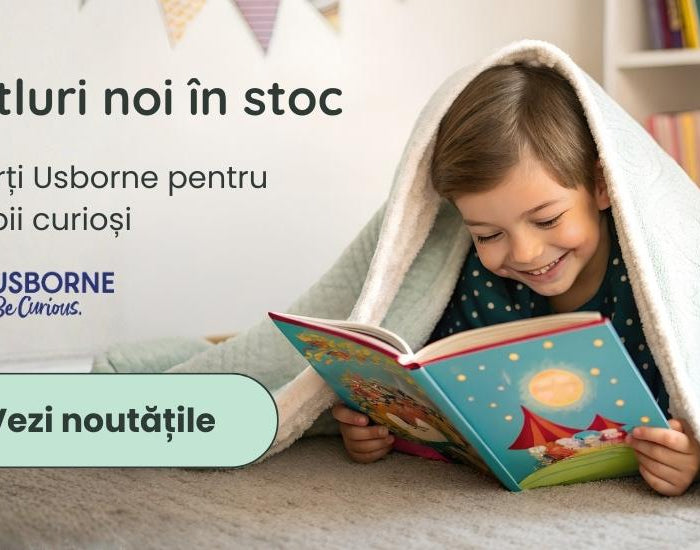 copil fericit citind o carte ilustrata sub o patura pe podea